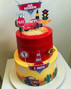 a birthday cake with cars and traffic signs on it's top tier is ready to be eaten