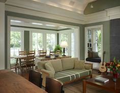 a living room filled with furniture and windows