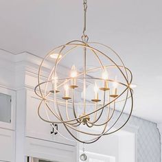 a chandelier hanging from the ceiling in a kitchen