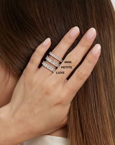 a woman's hand with three rings on it and the words mini petite luve