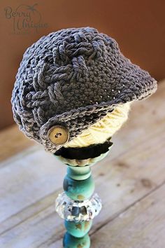 a crocheted hat sitting on top of a wooden table