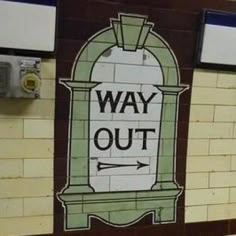 there is a sign on the wall that says way out and an arrow pointing to the right