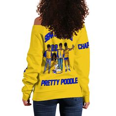 the back of a woman's yellow sweatshirt with an image of three people on it