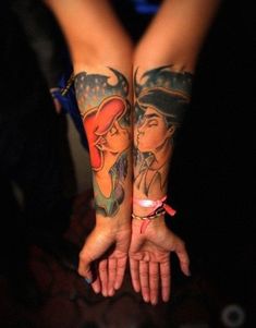 two people with tattoos on their arms