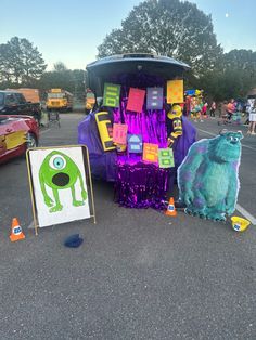 an odd looking vehicle parked in a parking lot with decorations on it's side