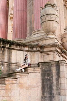 a woman is sitting on the steps outside