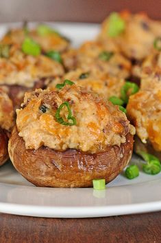 some stuffed mushrooms are on a white plate