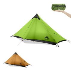 someone holding up a green and black tent with two other tents in front of it