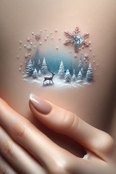 a woman's stomach with snowflakes on it and a deer in the background