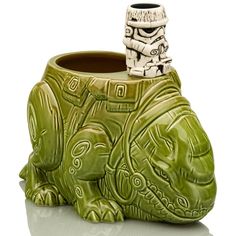 a green ceramic vase with a star wars character on it's face and mouth