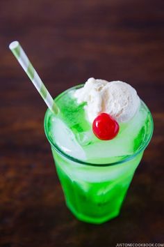 a green drink with ice cream and a cherry on top