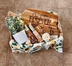 a basket filled with personalized items on top of a tiled floor next to a potted plant