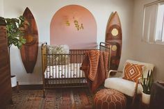 a baby's room with surfboards on the wall and a crib in the corner