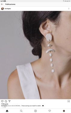 an image of a woman wearing some kind of earrings on her neck with pearls hanging from it