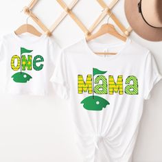 two t - shirts that say one mama and one baby are hanging on the wall