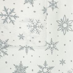 snowflakes and polka dots are on the white sheeting that is folded up