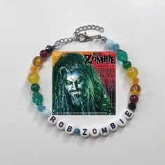 Rob Zombie Album Cover Bracelet   All Jewelry is Handmade with love and care by myself, Gabby. These are limited quantity while supplies last however, if something is sold out, message me to see if I can make you one! Every sale goes back into growing my shop and helps my dream of turning my small business into a fulltime job!🖤 Made with: glass beads, and plastic letter beads on a stainless steel wire with a 4cm stainless steel adjustable chain.  * Length is 20cm + 4cm chain * IMPORTANT:  Pleas Twd Bracelet, 80s Emo, Zombie Gifts, Bracelet Stuff, Diy Kandi Bracelets, Band Bracelets, Diy Kandi, Beaded Braclets, Couple Presents