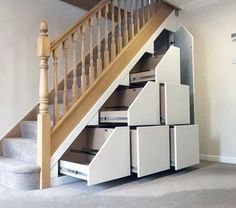 an under stair storage unit with drawers underneath the stairs