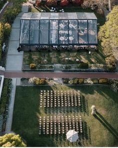 an aerial view of a wedding venue in the middle of a garden with rows of chairs