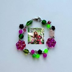 this handmade bracelet is inspired by "femininomenon" by chappell roan! featuring glass beads and czech glass beads in pink and green! the bracelet measures approx 7.5". Trendy Green Beaded Chain Bracelet, Trendy Green Beaded Bracelet, Bohemian Pink Beaded Bracelets Czech Glass, Bohemian Pink Beaded Bracelets From Czech Glass, Pink Bohemian Beaded Bracelets In Czech Glass, Whimsical Green Beaded Bracelets, Pink Beaded Bracelets With Czech Glass, Pink Czech Glass Bracelets With Colorful Beads, Pink Czech Glass Beaded Bracelets