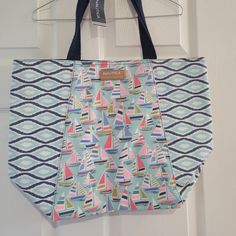 a blue and pink bag hanging from a door