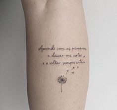 a dandelion tattoo on the left arm reads,'aprenda con as promessasm, is always - new - never - ever - to -