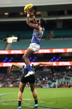 a man jumping in the air to catch a ball