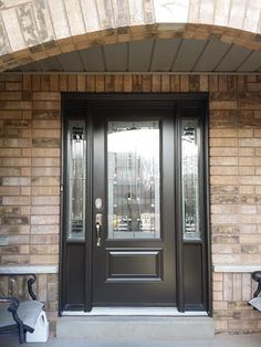 the front door to a building with two benches on either side and an entryway