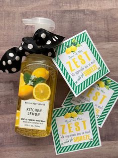 some lemons are sitting in a jar next to tags on a wooden table with polka dots