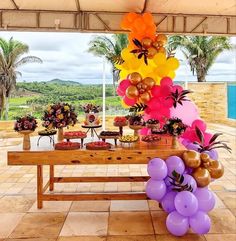 an outdoor party with balloons and desserts