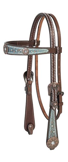 a brown and blue horse bridle with silver accents on the reins, in front of