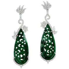 These stunning hand carved Jade earrings are crafted in 18-karat white gold. It is set in 18.5 carats Jade and 1.9 carats of sparkling diamonds. FOLLOW MEGHNA JEWELS storefront to view the latest collection & exclusive pieces. Meghna Jewels is proudly rated as a Top Seller on 1stDibs with 5 star customer reviews. All items manufactured by us are handmade and can be customized or redesigned. Composition Size-57X16 MM Total Weight-14.746 Gold Weight(Gms)-10.666 Diamond Wt(Cts)-1.9 Jade Wt(Cts)-18. Luxury Carved Earrings, Luxury Carved Earrings For Formal Occasions, Elegant Carved Earrings For Formal Occasions, Luxury Platinum Diamond Earrings Hallmarked, Elegant Round Carved Earrings, Elegant Carved Round Earrings, Elegant Carved Drop Earrings, Luxury Earrings With Intricate Design, Luxury Diamond Earrings With Intricate Design For Anniversary