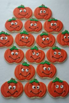 pumpkin cookies with faces drawn on them