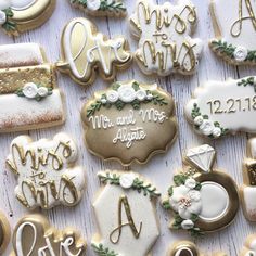 decorated cookies are arranged on a table for a wedding party or special occasion to be served