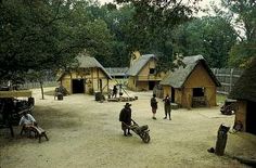 people are walking around in an old fashioned village