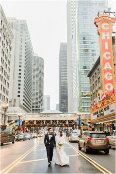 a bride and groom walking down the street in chicago