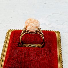 Vintage Hand Carved Flowers Oval Coral Cabochon Ring - Gold Tone - Size 7.5 In very good condition overall with an area of plating loss on the palm of the hand - not obvious when worn. The hand carved natural salmon pink coral is not color enhanced. The oval coral cabochon is carved with forget-me-not flowers and measures 11/16 inch (17mm) by 1/2 inch (12mm). The ring size is 7.5. The band width is 1/16 inch (2.5mm). It well made of high quality materials. Please note the area of plating loss on Antique 14k Gold Oval Cabochon Jewelry, Vintage Oval Cabochon Ring For Gift, Ornate Oval Cabochon Rings, Vintage Oval Gold Cabochons, Vintage Coral Oval Jewelry, Carved Flowers, Coral Roses, Jewelry Tags, Rose Necklace