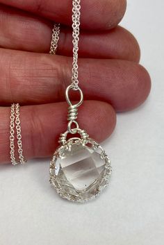 "This pendant features a 12x13 mm, A+ grade HERKIMER DIAMOND quartz crystal. This completely natural double terminated (diamond shaped) quartz crystal was hand mined in Middleville, NY. A clear stone good terminations that is near perfect, with a great tabular shape. This unique wire wrap design has a fancy bezel setting that really shows off clarity of this beautiful stone. You will receive this EXACT pendant. Handmade in the USA with love, by me. I make every piece of jewelry myself. Handcrafted with sterling silver (.925) wire.  Add on a sterling silver chain for a complete necklace if you wish. The 16\" chain is pictured, please note that the longer lengths are slightly thicker.  Herkimer Diamonds are natural double terminated (diamond shaped) quartz crystals found in Herkimer County, Diamond White Crystal Necklace For Gift, Faceted Crystal Pendant Jewelry, Sterling Silver Faceted Pendant Crystal Necklace, Faceted Crystal Pendant Necklace, Faceted Crystals As Gifts, Clear Pendant Necklaces For Anniversary, Faceted Crystal Gift, Silver Faceted Pendant Crystal Necklaces, Silver Faceted Pendant Crystal Necklace