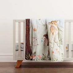 a baby crib with an animal themed blanket