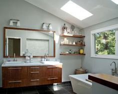 a bath room with a tub a sink and a window