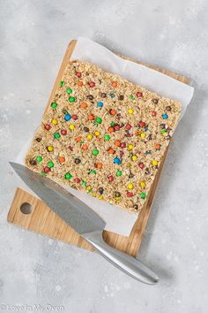 a wooden cutting board topped with cereal bars