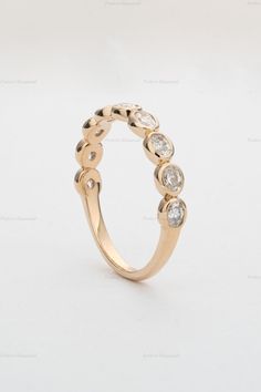 a gold ring with five diamonds on it