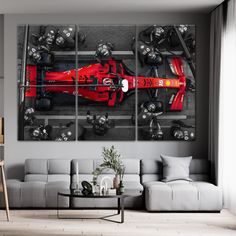 a modern living room with a red race car on the wall and grey couches