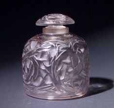 a clear glass bottle with a silver lid