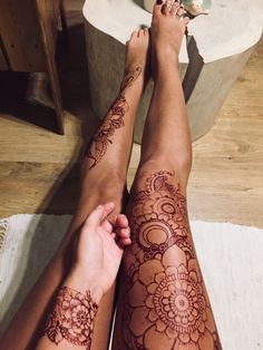 two people with tattoos on their legs