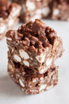 chocolate and marshmallows are stacked on top of each other in the shape of squares