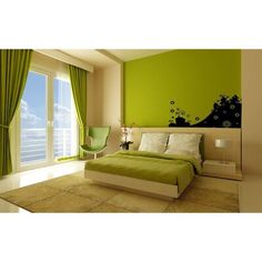 a bedroom with green walls and curtains on the windowsills is pictured in this image