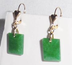 21CTS NATURAL UNTREATED SQUARE CUT EMERALD GEMSTONE EARRINGS. HIGH-QUALITY 14KT YELLOW GOLD-FILLED HEART LEVER BACK EARRINGS. NICE CLEAN STONES Earrings measured from the top of lever backs are 1 1/2" Tall x 1/2" Wide. Both stones weigh 21cts, each stone is 10.5cts.  I CAN CHANGE THE LEVER BACKS TO ANOTHER FINDING UPON REQUEST. I DO NOT CHARGE FOR THIS SERVICE UNLESS YOU WISH FOR SOLID GOLD.  EARRINGS COME IN A NICE CASE AND OUTER 2PC GIFT BOX. STONE DETAILS Stones: Natural Emeralds / Nice clean Rectangular Gemstone Earrings For Anniversary, Formal Green Heart-shaped Earrings, Rectangular Yellow Gold Earrings With Gemstone, Formal Earrings With Lever Back And Rectangular Shape, 14k Gold Rectangular Earrings For Anniversary, Pink Topaz Earrings, Columbian Emeralds, Pink Topaz, Leverback Earrings