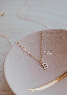 Is there anything sweeter than a tiny single initial? We don’t think so! 8 x 6mm uppercase block letter is suspended from delicate cable or scout chain. Offered in 16" or 18" lengths. Available in 14kt Gold Fill + Sterling Silver. Kayla layers it with our Pearl Linked Necklace. Handmade in Eau Claire, WI. Our jewelry is handmade so each piece will be unique and may vary slightly from what is pictured. Initial Pendant Necklace With Cable Chain, Everyday Tiny Initial Pendant Charm Necklace, Dainty Sterling Silver Initial Necklace With Cable Chain, 14k Gold Initial Necklace With Cable Chain For Everyday, Initial Pendant Charm Necklace With Cable Chain, Dainty Tiny Initial Pendant Necklace, 14k Gold Filled Initials Charm Necklace For Everyday, Everyday 14k Gold Filled Initial Pendant Necklace, Everyday 14k Gold Filled Initials Charm Necklace