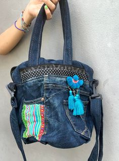 This is a cool Denim bag, handmade decorated with antique embroidered cloth. It's a unique crossbody bag. You can use as a croosbody bag, shoulder bag or a tote bag, the strap is adjustable.   There are 2 zippers pockets, big space. And there are 4 pockets on the Jeans are usable. The bottom of the bag is round. Easy for daily use. Size : Width of the bottom of the bag 23 cm. Height 26 cm, Open space on the top 26 cm Strap for shoulder 23 cm, strap for crossing body is adjustable. Unique Crossbody Bag, Boho Shoulder Bag, Jean Purses, Cool Denim, Denim Crossbody, Denim Tote Bags, Denim Tote, Upcycled Denim, Denim Bag